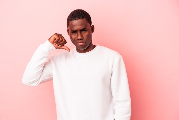 Young African American man isolated on pink background showing thumb down, disappointment concept.