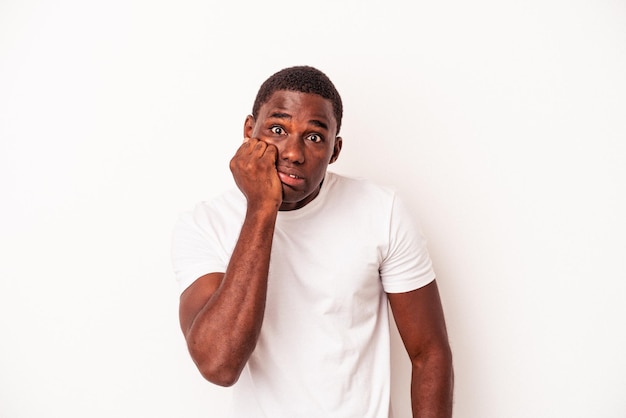 Young African American man isolated on white background biting fingernails nervous and very anxious