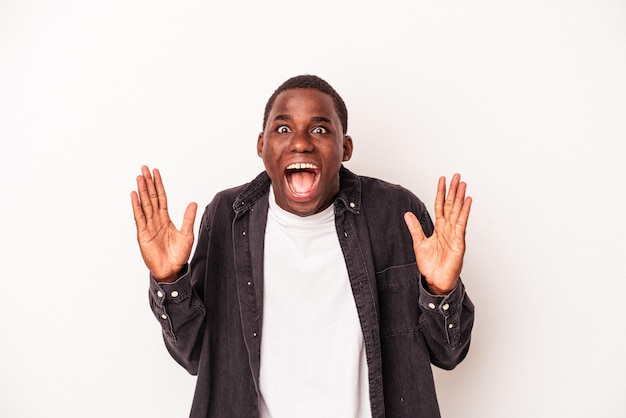 Young African American man isolated on white background celebrating a victory or success, he is surprised and shocked.