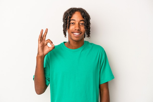 Young african american man isolated on white background cheerful and confident showing ok gesture.