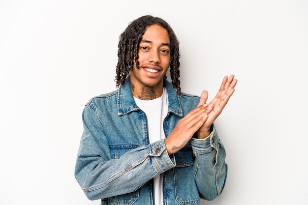 Young African American man isolated on white background feeling energetic and comfortable rubbing hands confident