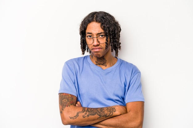 Young African American man isolated on white background frowning face in displeasure keeps arms folded