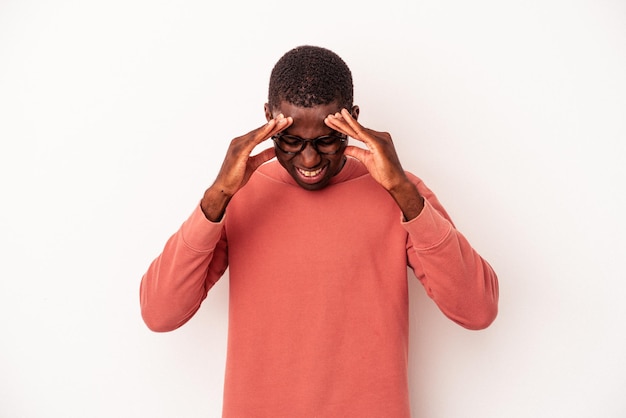 Young African American man isolated on white background having a head ache, touching front of the face.