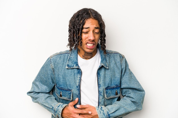 Young African American man isolated on white background having a liver pain stomach ache