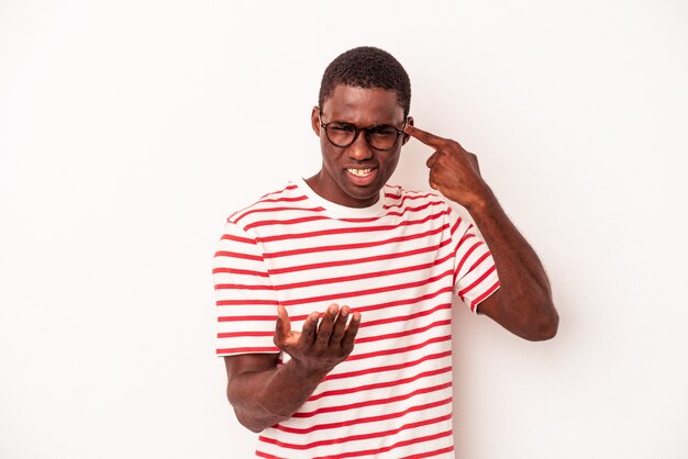 Young African American man isolated on white background holding and showing a product on hand.