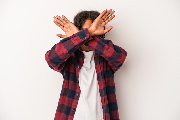 Young african american man isolated on white background keeping two arms crossed, denial concept.