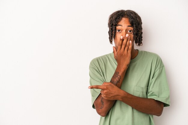 Young african american man isolated on white background pointing to the side