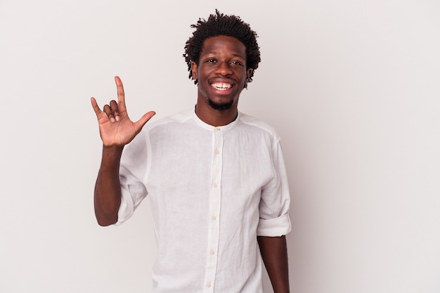 Young african american man isolated on white background  showing a horns gesture as a revolution concept.