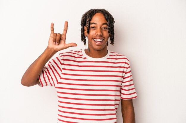 Young african american man isolated on white background showing a horns gesture as a revolution concept.