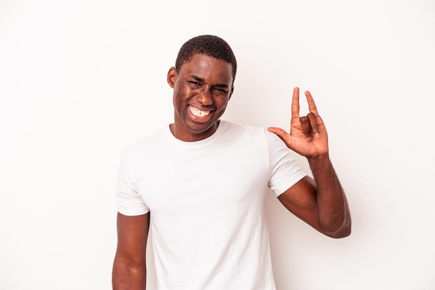 Young African American man isolated on white background showing a horns gesture as a revolution concept.