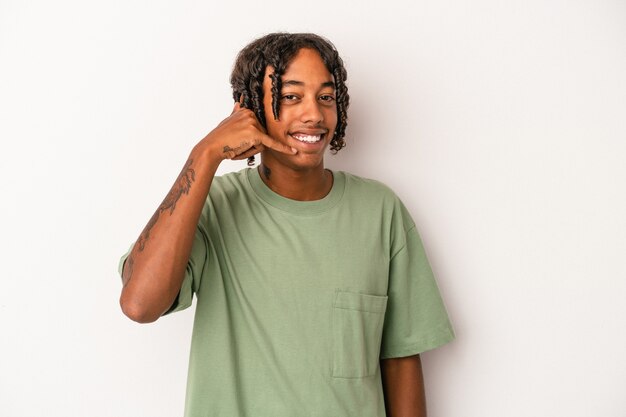 Young african american man isolated on white background showing a mobile phone call gesture with fingers.