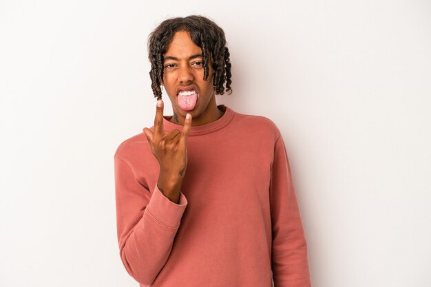 Young african american man isolated on white background showing rock gesture with fingers