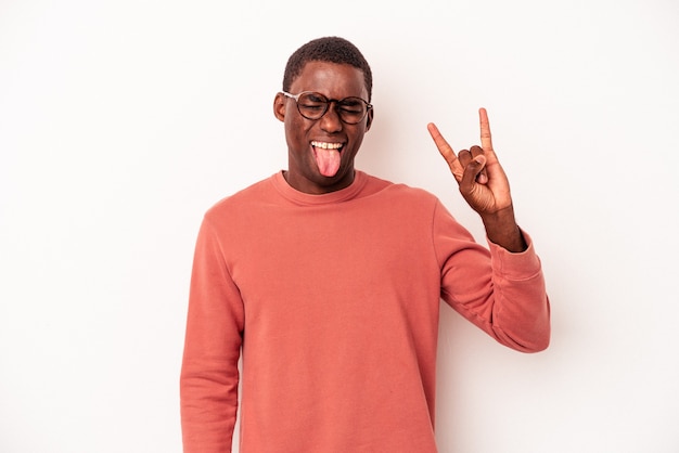 Young African American man isolated on white background showing rock gesture with fingers