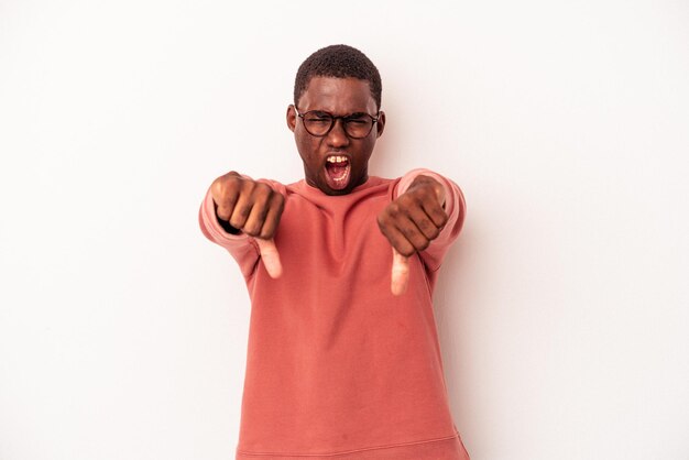 Young African American man isolated on white background showing thumb down and expressing dislike.