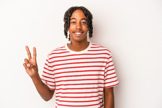 Young african american man isolated on white background showing victory sign and smiling broadly.