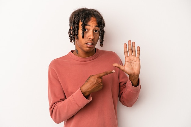 Young african american man isolated on white background smiling cheerful showing number five with fingers.