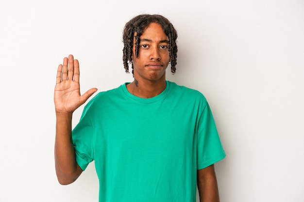 Young african american man isolated on white background smiling cheerful showing number five with fingers.