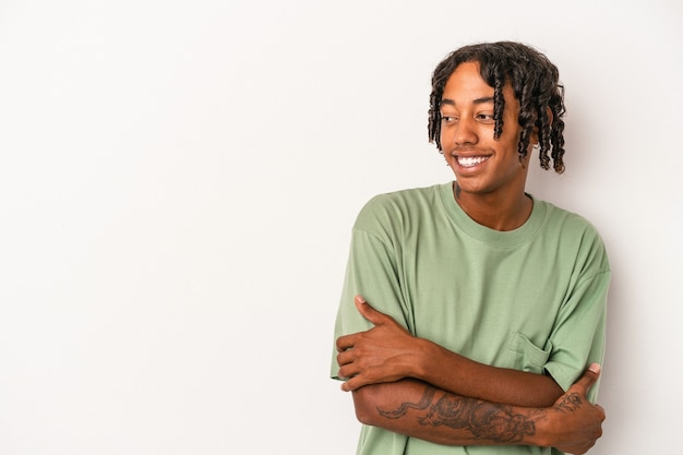 Young african american man isolated on white background smiling confident with crossed arms.