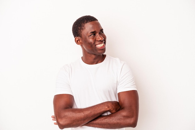 Young African American man isolated on white background smiling confident with crossed arms.