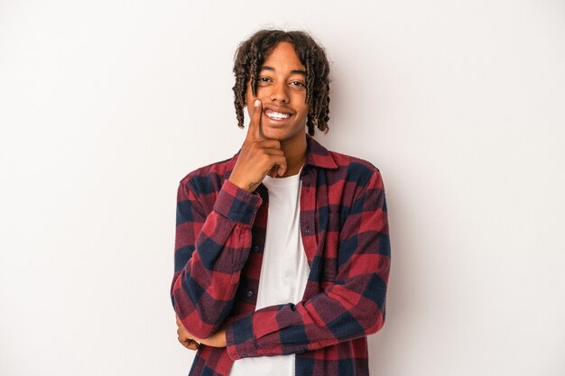 Young african american man isolated on white background smiling happy and confident, touching chin with hand.