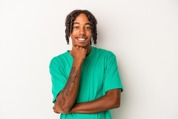 Young african american man isolated on white background smiling happy and confident, touching chin with hand.