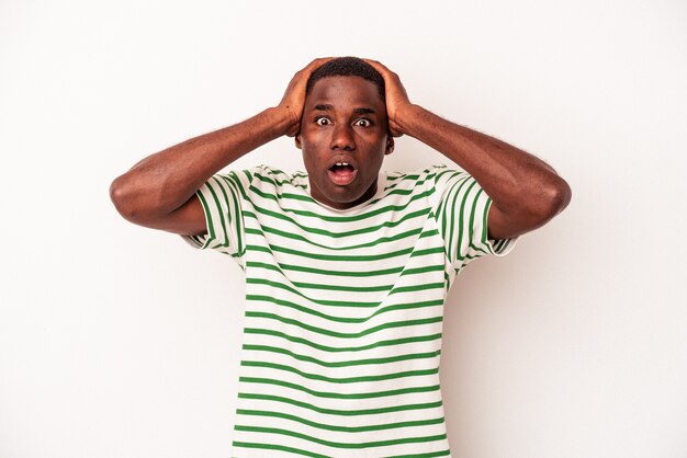 Young African American man isolated on white background surprised and shocked.