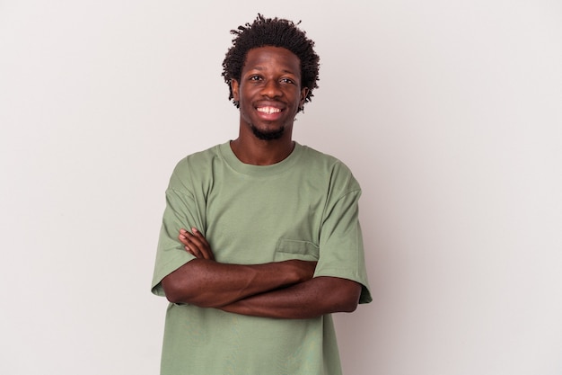 Young african american man isolated on white background  who feels confident, crossing arms with determination.