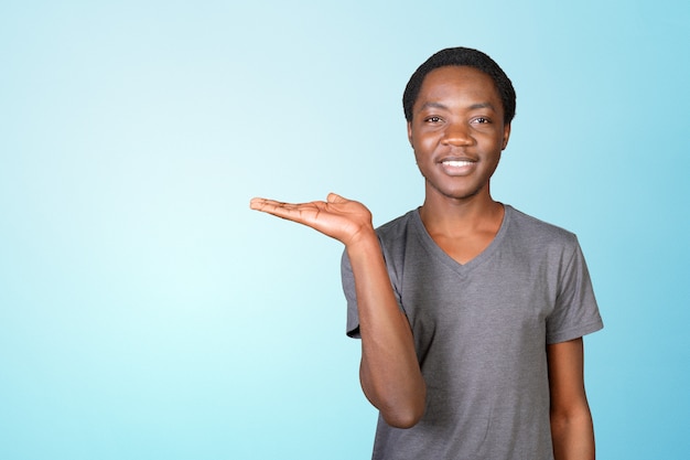 Young african american man pointing copyspace