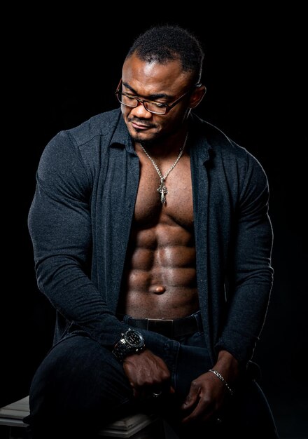 Young African American man in studio in glasses