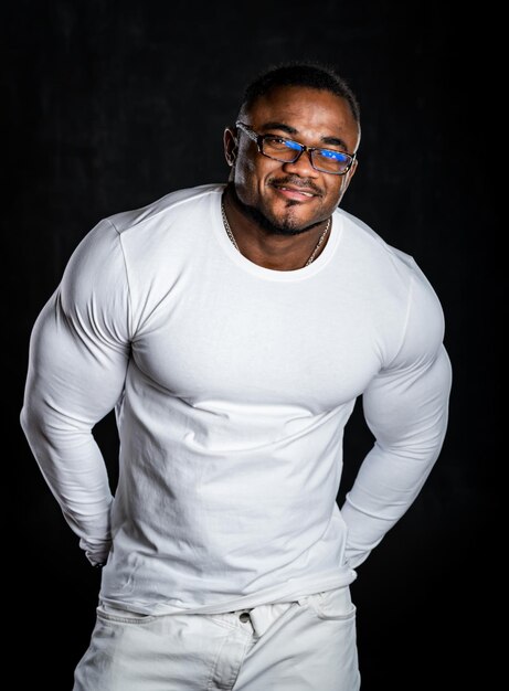 Young African American man in studio in glasses