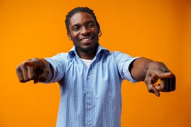 Young african american man wearing casual clothes pointing to you