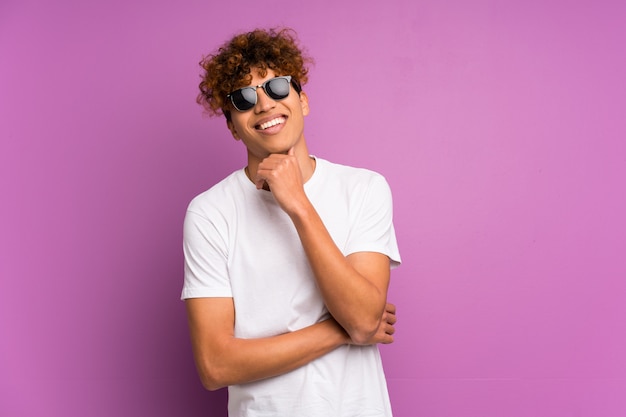 Young african american man with glasses and smiling