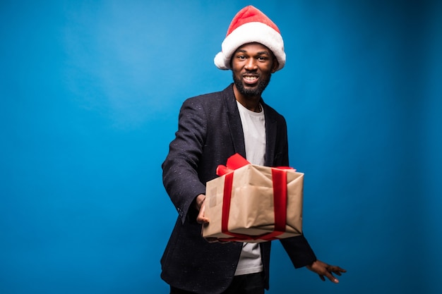 Young african american man with white shirt holding gift boxes in hands