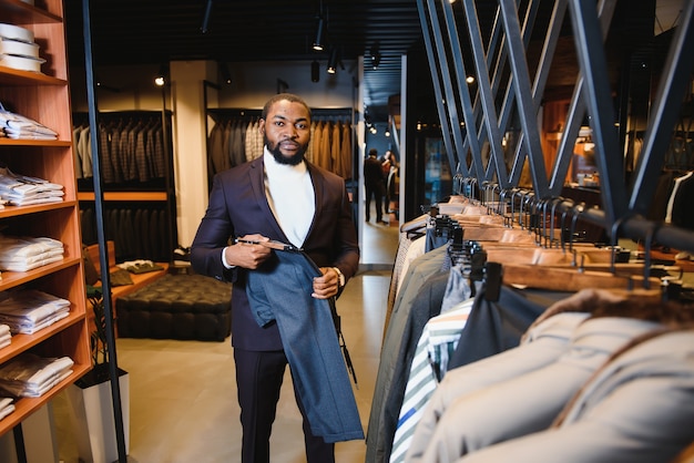 Young african-american man working in clothing store