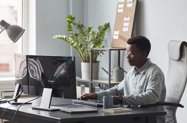 Young African American Man Working at Desk