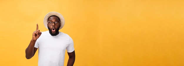 Young african american man over yellow background pointing upwards