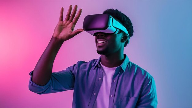 Young african american mans playing in vr glasses in neon light on gradient