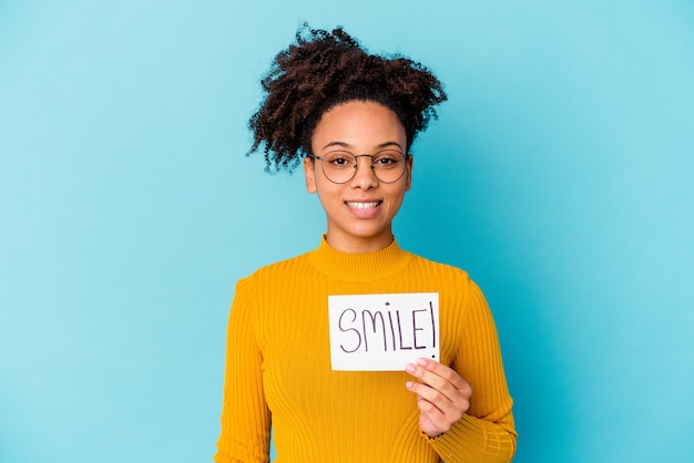 Young african american mixed race woman holding a smile concept happy, smiling and cheerful.