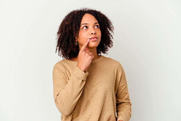 Young african american mixed race woman isolated looking sideways with doubtful and skeptical expression.