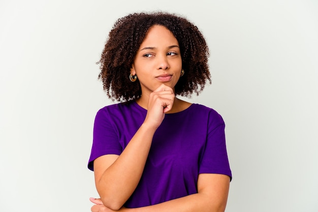 Young african american mixed race woman isolated looking sideways with doubtful and skeptical expression.