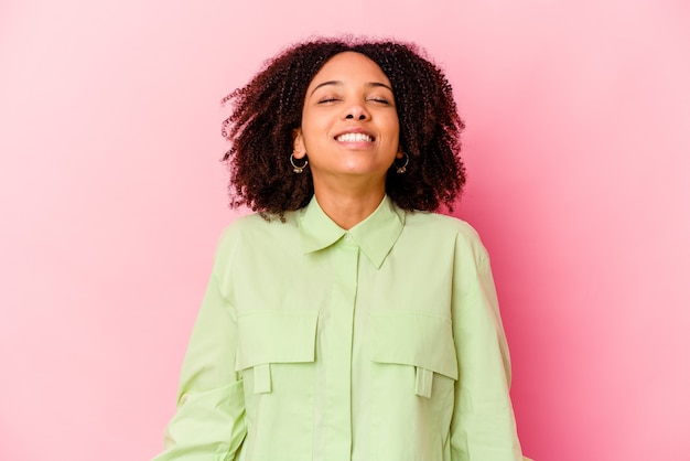 Young african american mixed race woman isolated relaxed and happy laughing, neck stretched showing teeth.