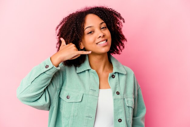 Young african american mixed race woman isolated showing a mobile phone call gesture with fingers.