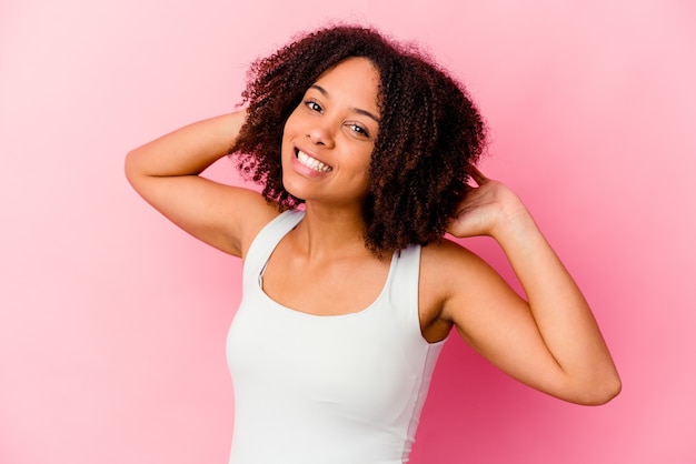 Young african american mixed race woman isolated stretching arms, relaxed position.