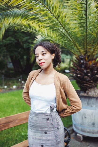 Young African American mixed race woman in park Fall or spring season