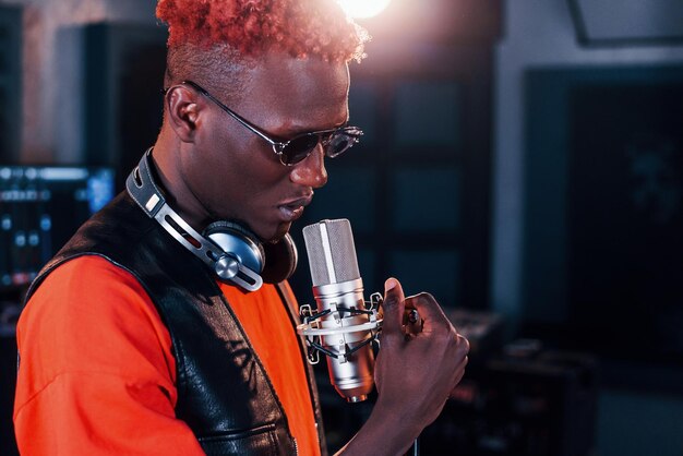 Young african american performer rehearsing in a recording studio