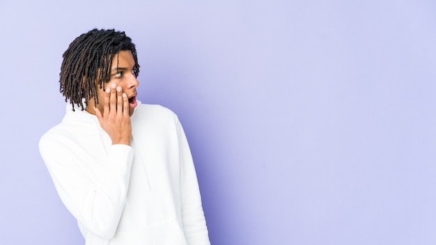 Young african american rasta man being shocked because of something she has seen.