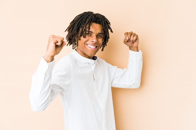 Young african american rasta man cheering carefree and excited. Victory concept.