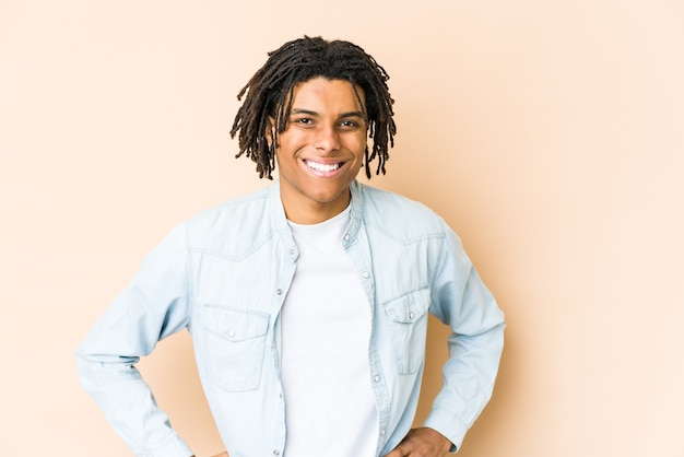 Young african american rasta man confident keeping hands on hips.