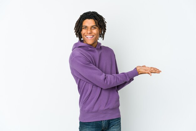 Young african american rasta man holding a copy space on a palm.