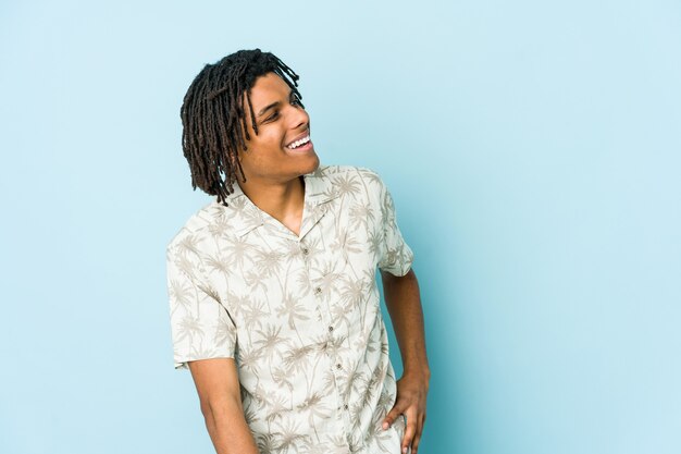 Young african american rasta man relaxed and happy laughing, neck stretched showing teeth.